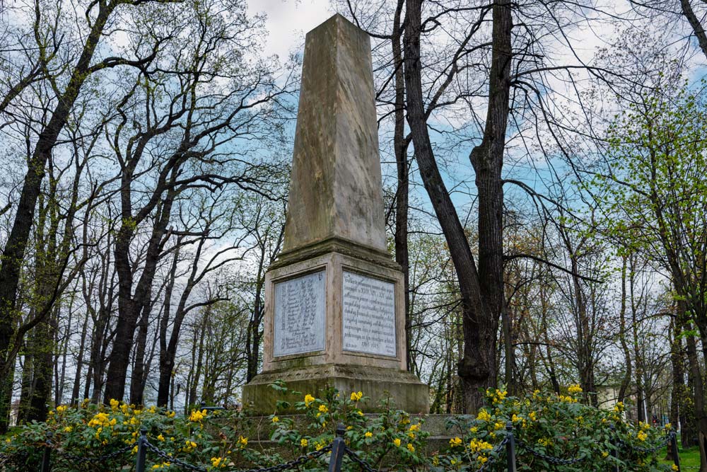 Obelisk w Świdnicy w ujęciu narożnym – po jednej stronie niemiecka tablica z nazwiskami, po drugiej polska tablica pamiątkowa z 2006 roku